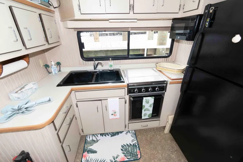 Slide: The Image of Compact kitchen in a 2004 Gibson 47 Classic boat with modern appliances. - 13