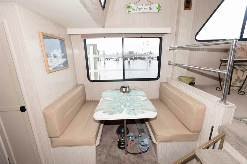 Slide: The Image of Cozy dining area in a 2004 Gibson 47 Classic houseboat with waterfront view. - 14