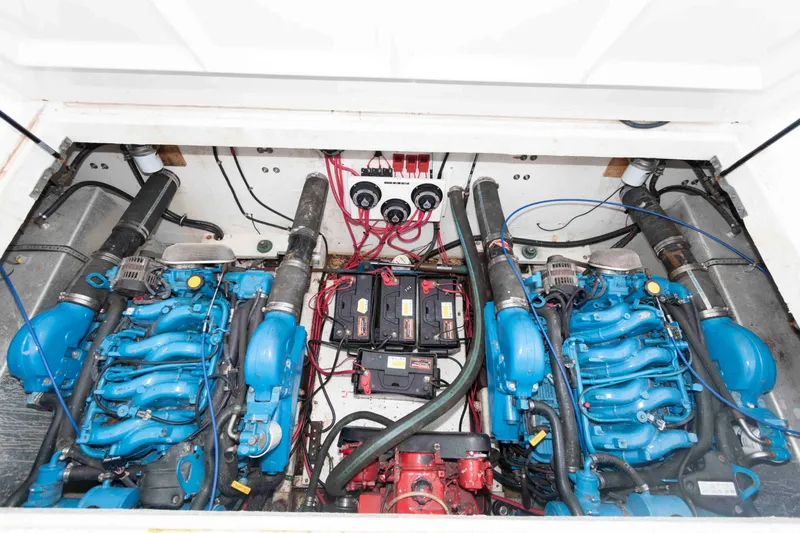 Slide: The Image of Engine compartment of a 2004 Gibson 47 Classic boat with dual blue engines. - 20
