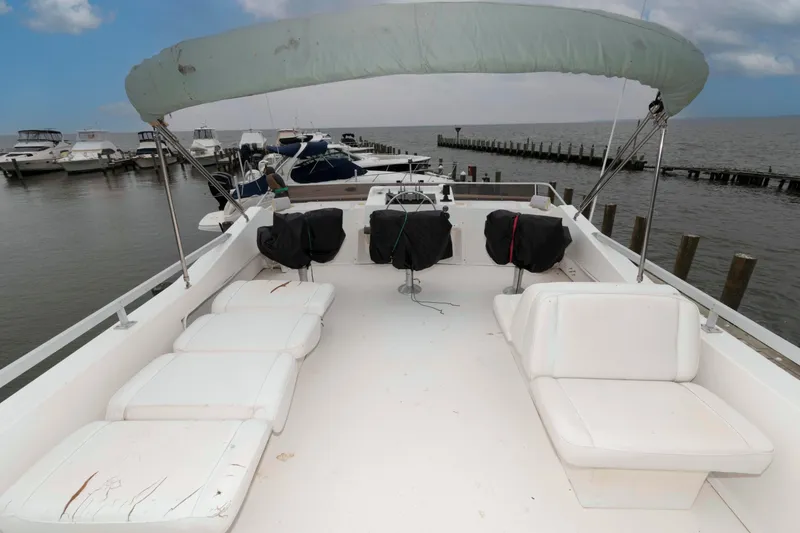 Slide: The Image of 2004 Gibson 47 Classic boat with spacious deck and seating at marina. - 3