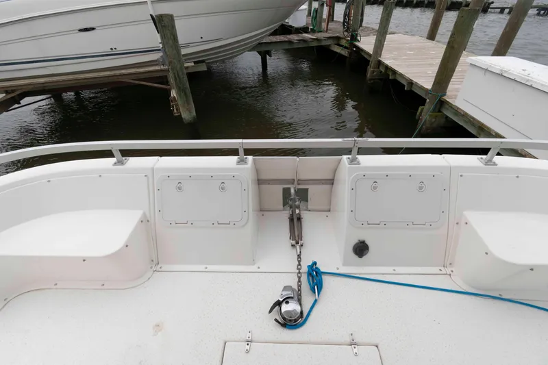 Slide: The Image of Rear deck of a 2004 Gibson 47 Classic boat docked at a marina. - 4