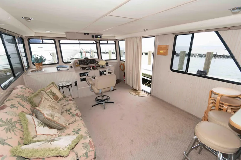 Slide: The Image of Interior of a 2004 Gibson 47 Classic houseboat with cozy seating and helm station. - 7
