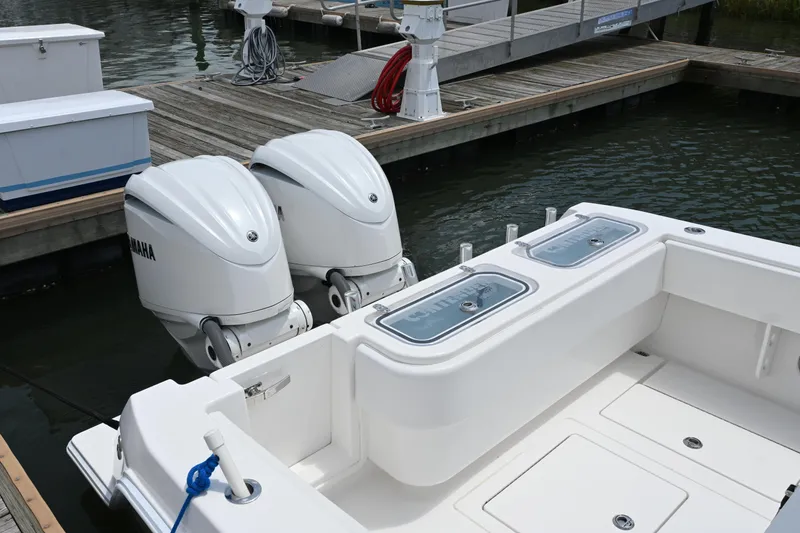 Slide: The Image of 2022 Contender 30 ST boat with twin Yamaha outboard engines docked at marina. - 10