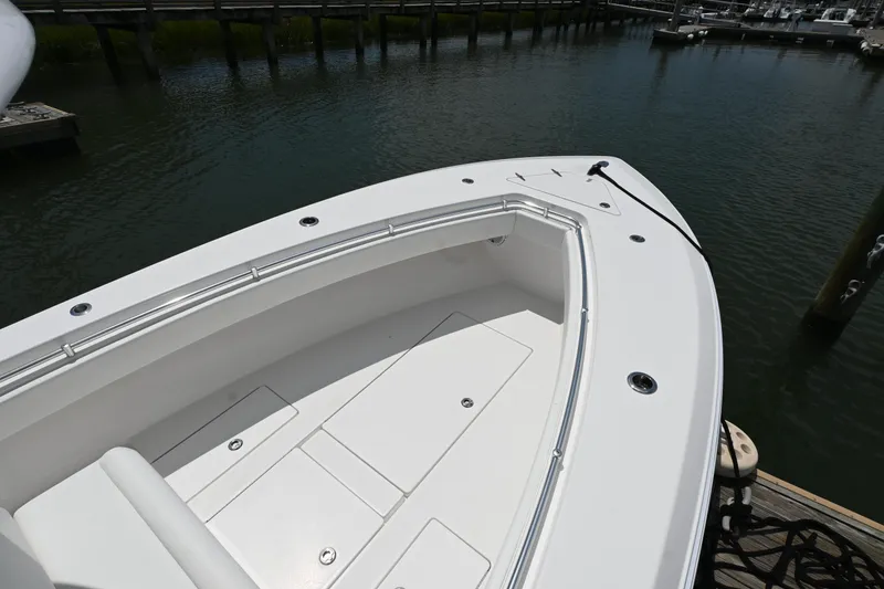 Slide: The Image of 2022 Contender 30 ST boat docked, showcasing spacious bow area and sleek design. - 13