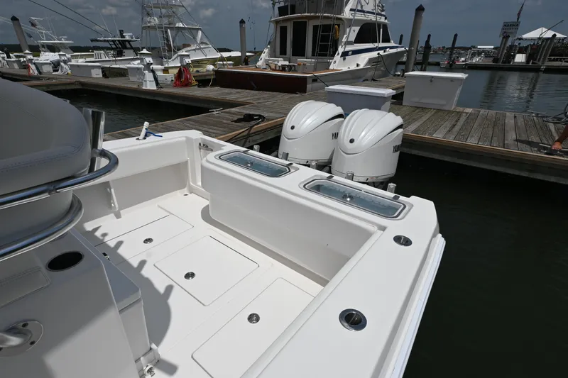 Slide: The Image of 2022 Contender 30 ST boat with dual Yamaha engines docked at marina. - 14