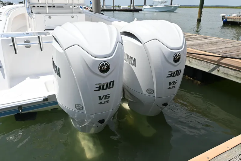 Slide: The Image of Twin Yamaha 300 V6 outboard engines on a 2022 Contender 30 ST boat at a dock. - 16