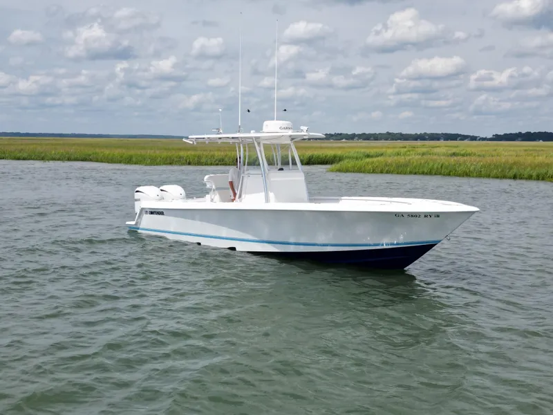 Slide: The Image of 2022 Contender 30 ST boat with dual Yamaha engines on calm water. - 3