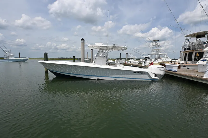 Slide: The Image of 2022 Contender 30 ST boat docked at marina under cloudy sky. - 4