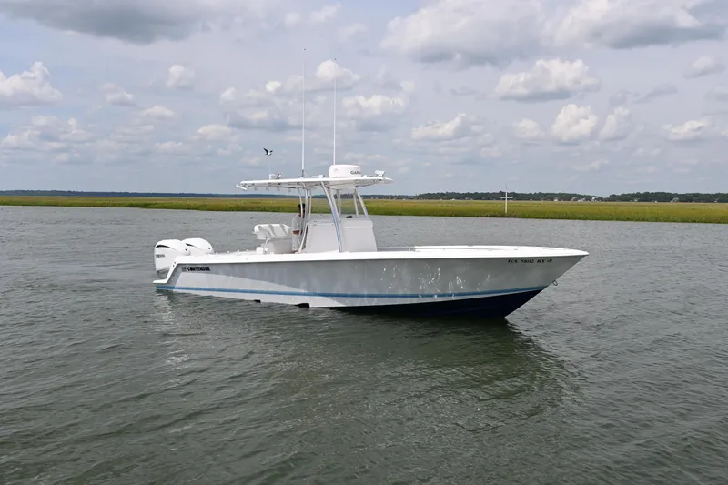 Slide: The Image of 2022 Contender 30 ST boat on calm water under cloudy sky. - 6