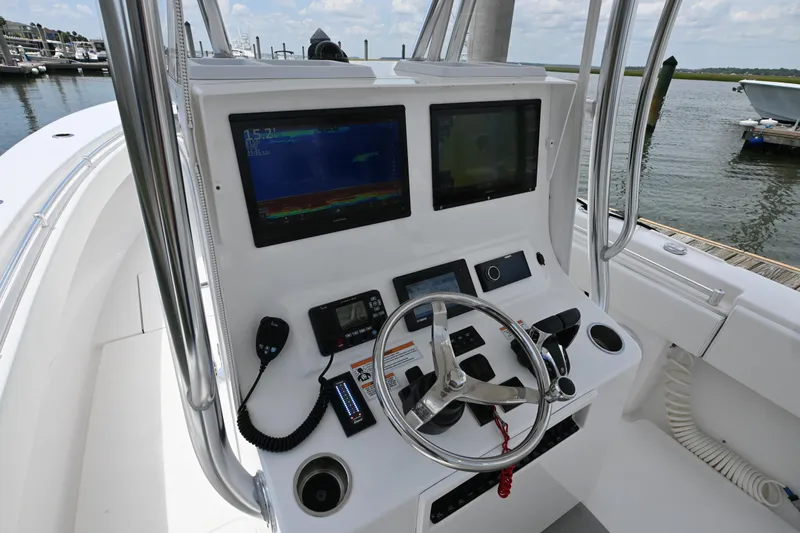 Slide: The Image of 2022 Contender 30 ST boat console with dual screens and steering wheel. - 7