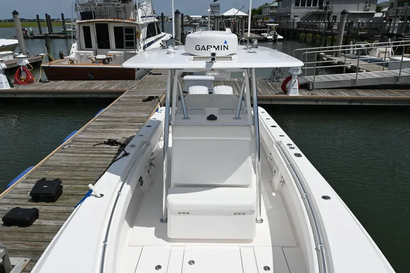 Slide: The Image of 2022 Contender 30 ST boat docked at marina, featuring Garmin equipment. - 8