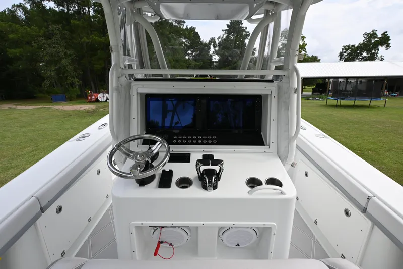 Slide: The Image of 2017 Yellowfin 36 boat console with steering wheel and navigation display. - 13