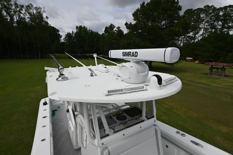 Slide: The Image of 2017 Yellowfin 36 boat with Simrad radar, set against a lush green landscape. - 15