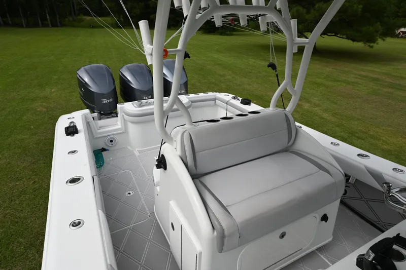 Slide: The Image of 2017 Yellowfin 36 boat with dual engines and cushioned seating on grassy area. - 16