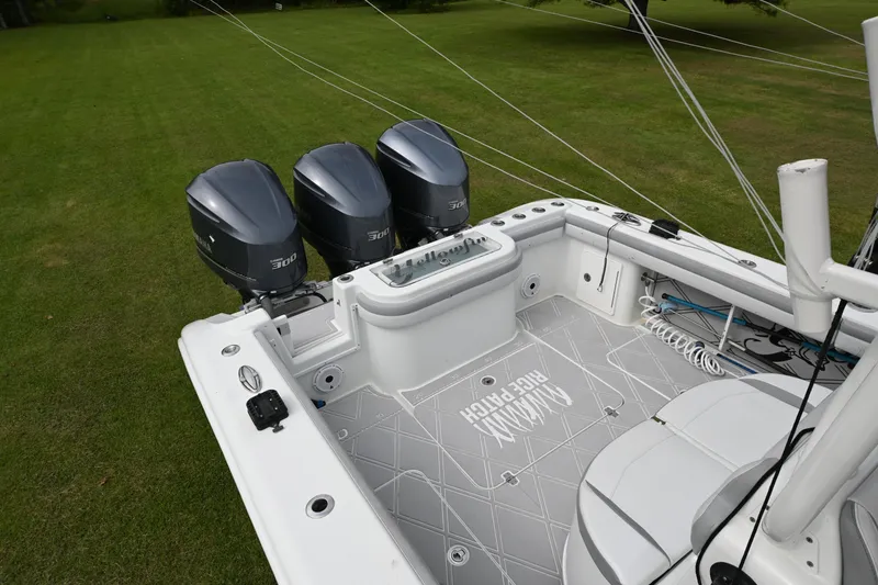 Slide: The Image of 2017 Yellowfin 36 boat with triple 300 horsepower engines on grassy field. - 17