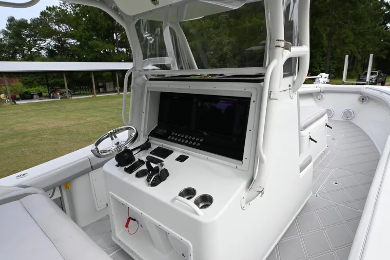 Slide: The Image of 2017 Yellowfin 36 boat helm with steering wheel and control panel. - 18