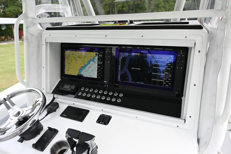 Slide: The Image of 2017 Yellowfin 36 boat dashboard with dual Simrad displays and steering wheel. - 20