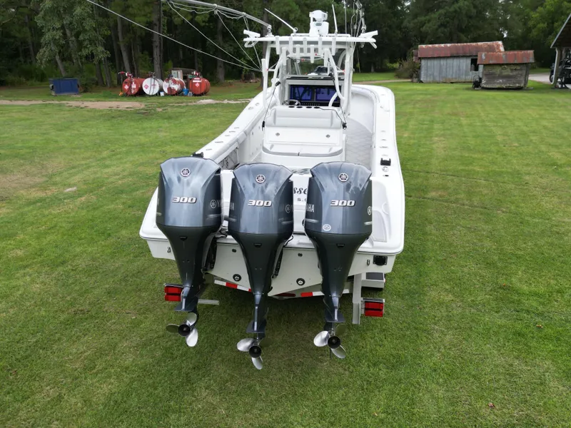 Slide: The Image of 2017 Yellowfin 36 boat with triple Yamaha 300 engines on grassy field. - 4