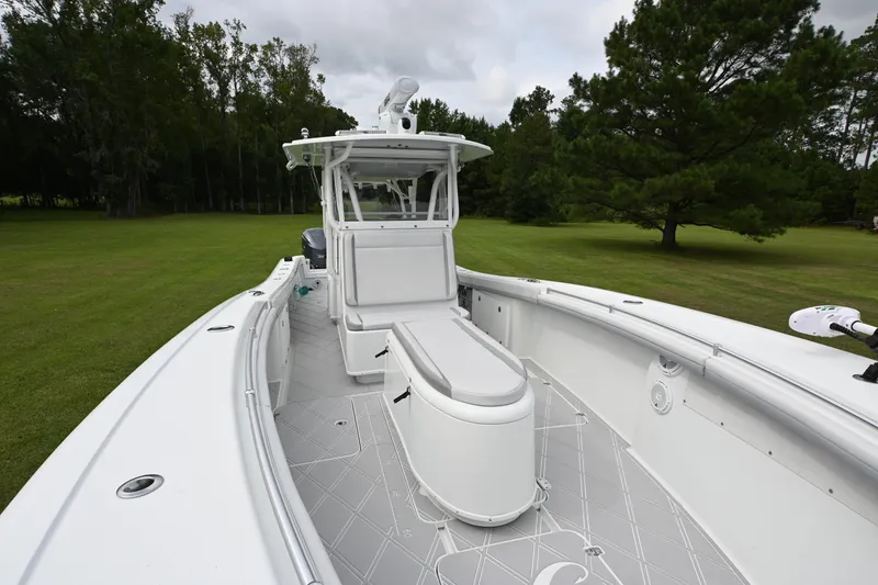 Slide: The Image of 2017 Yellowfin 36 boat on grassy field, surrounded by trees. - 9