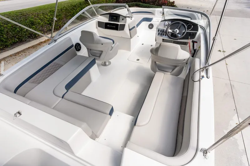 Slide: The Image of 2021 Hurricane SunDeck 217 OB boat interior with spacious seating and modern dashboard. - 16
