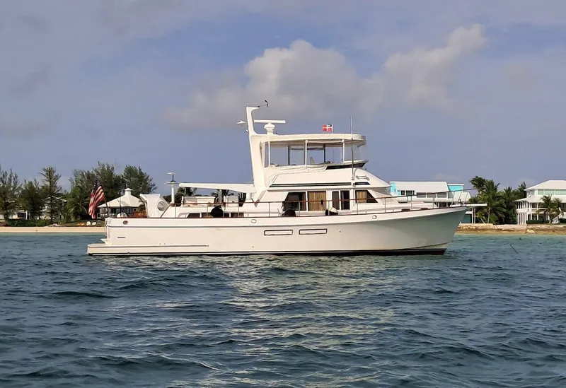 Slide: The Image of 1999 Ocean Alexander 48/51 Classico yacht cruising near a tropical shoreline. - 1