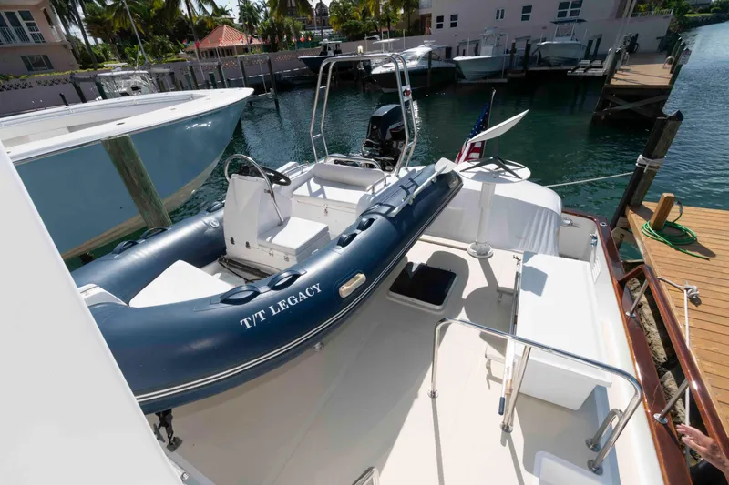 Slide: The Image of 1999 Ocean Alexander 486/510 Classico yacht with inflatable tender docked at marina. - 12