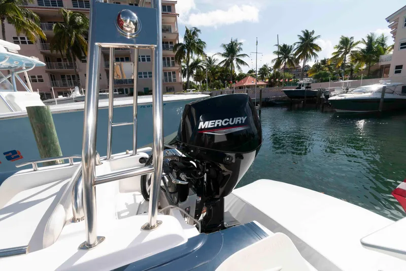 Slide: The Image of 1999 Ocean Alexander 486/510 Classico with Mercury outboard motor, docked near palm trees. - 15