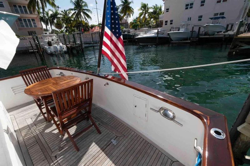 Slide: The Image of Deck of 1999 Ocean Alexander 486/510 Classico yacht with wooden table and chairs. - 17
