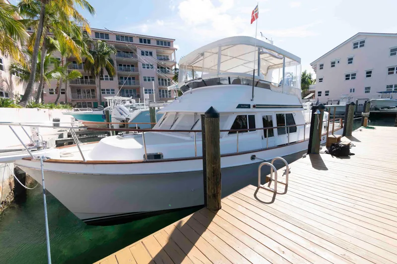 Slide: The Image of 1999 Ocean Alexander 486/510 Classico yacht docked at marina with palm trees. - 2