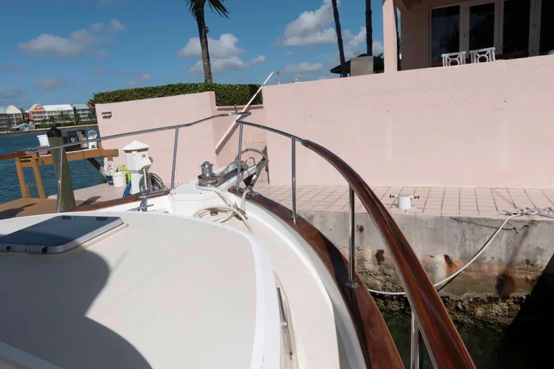 Slide: The Image of 1999 Ocean Alexander 486/510 Classico yacht docked by a waterfront home. - 23