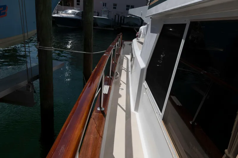 Slide: The Image of 1999 Ocean Alexander 486/510 Classico yacht deck with polished wood railing. - 24
