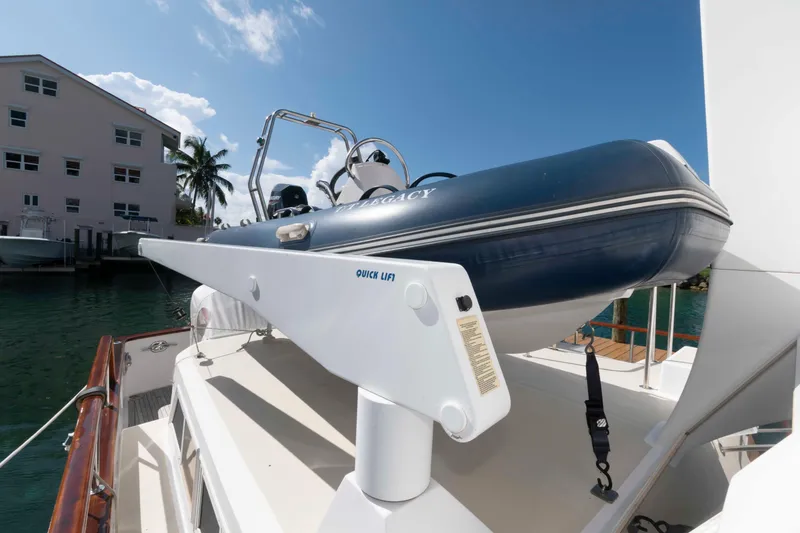 Slide: The Image of 1999 Ocean Alexander 486/510 Classico yacht with a mounted inflatable boat on deck. - 25