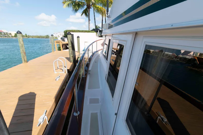 Slide: The Image of 1999 Ocean Alexander 486/510 Classico yacht docked by a wooden pier, sunny day. - 26