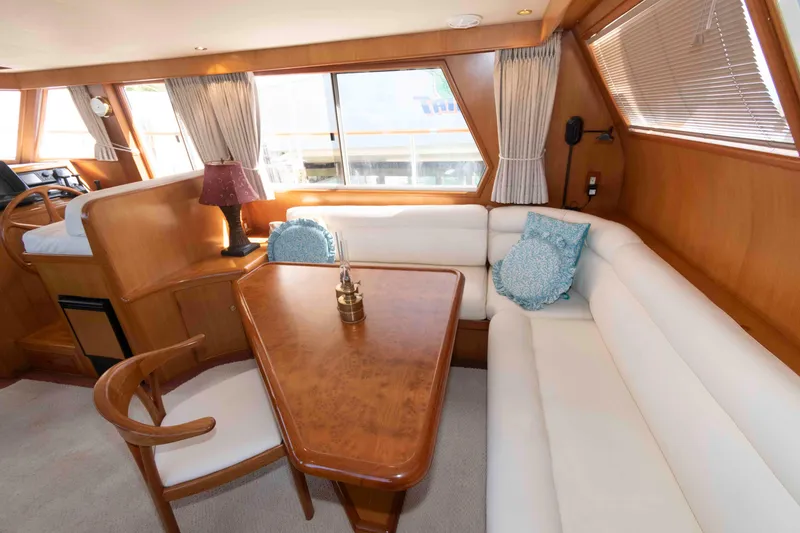 Slide: The Image of Luxurious interior of 1999 Ocean Alexander 486/510 Classico yacht with elegant seating and table. - 28