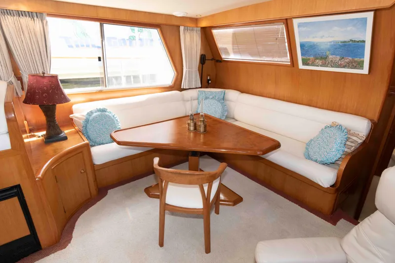 Slide: The Image of 1999 Ocean Alexander 486/510 Classico yacht interior with cozy dining area and elegant decor. - 29