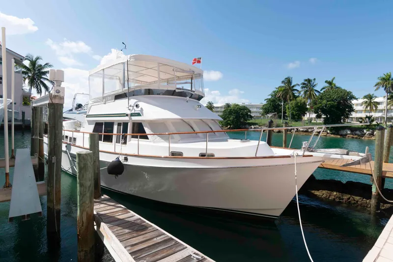 Slide: The Image of 1999 Ocean Alexander 486/510 Classico yacht docked in a tropical marina setting. - 3