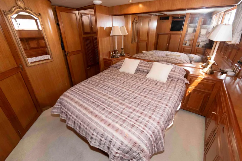 Slide: The Image of Luxurious 1999 Ocean Alexander 486/510 Classico yacht bedroom with wood paneling and cozy bedding. - 39