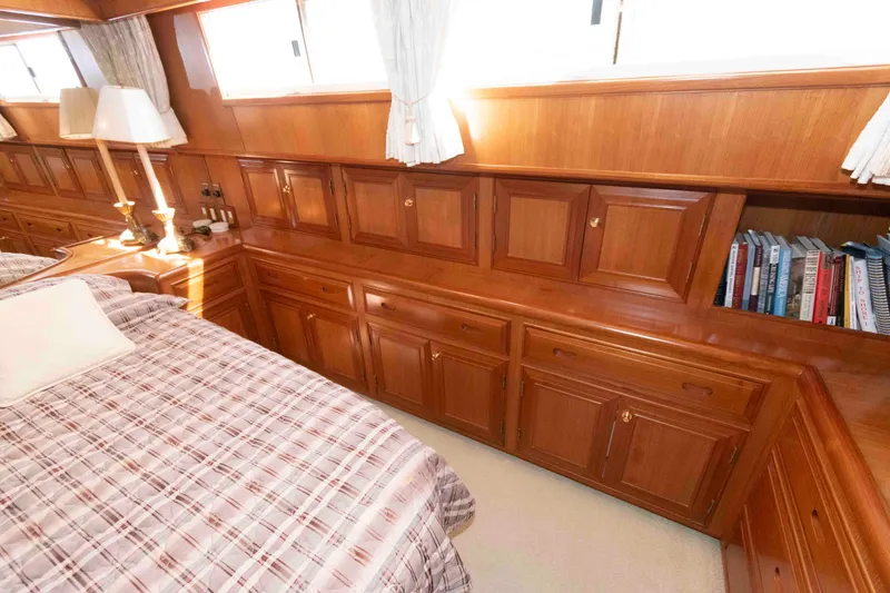 Slide: The Image of Luxurious wooden cabin interior of 1999 Ocean Alexander 486/510 Classico yacht with bed and bookshelves. - 40
