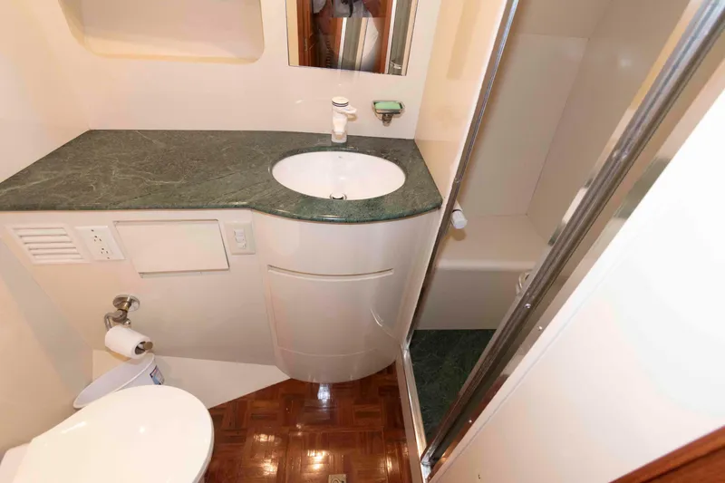 Slide: The Image of Bathroom interior of 1999 Ocean Alexander 486/510 Classico yacht, featuring green countertop and shower. - 43