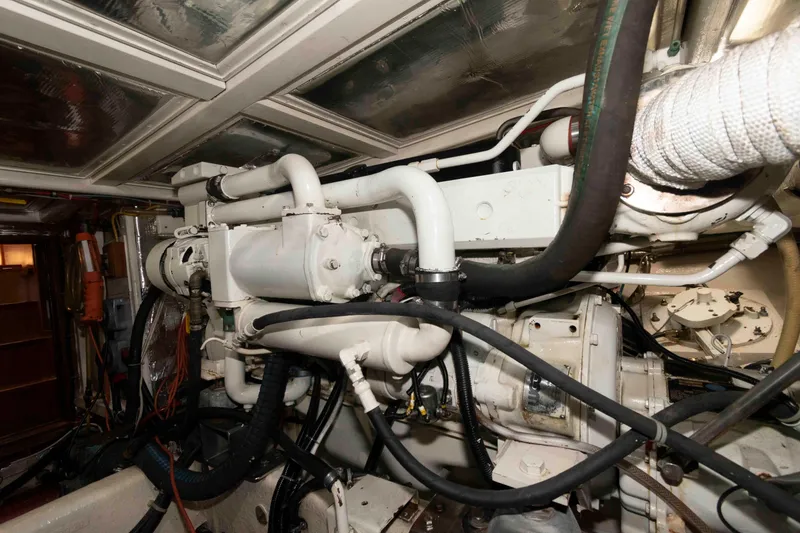 Slide: The Image of Engine room of 1999 Ocean Alexander 486/510 Classico yacht, showcasing complex machinery and piping. - 51