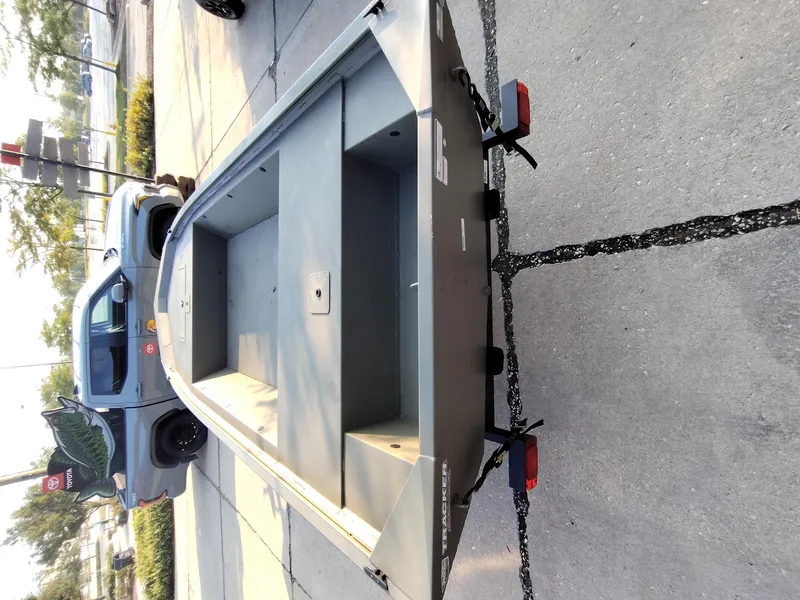 Slide: The Image of 2026 Tracker GRIZZLY 1648 AWL boat on trailer in parking lot. - 4