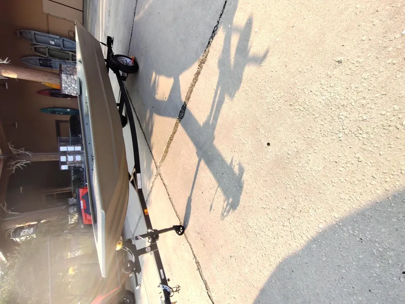 Slide: The Image of 2026 Tracker GRIZZLY 1648 AWL boat on trailer in driveway. - 5