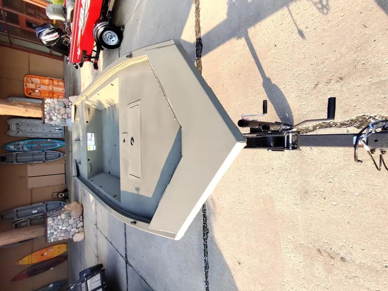 Slide: The Image of 2026 Tracker GRIZZLY 1648 AWL boat on trailer, parked on concrete surface. - 9