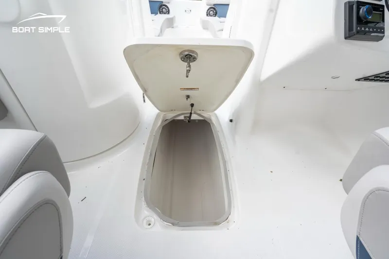 Slide: The Image of 2025 Hurricane SunDeck 2400 OB boat storage compartment open, showcasing interior space. - 7