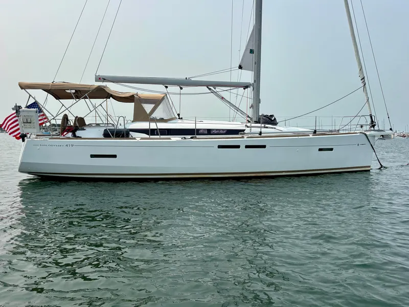 Slide: The Image of 2019 Jeanneau Sun Odyssey 419 sailboat on calm water, side view. - 0