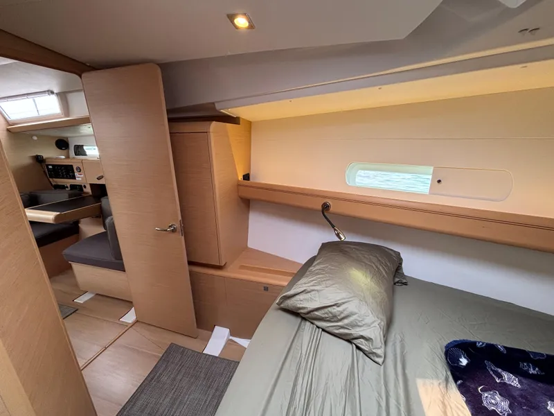 Slide: The Image of Interior of 2019 Jeanneau Sun Odyssey 419 yacht, featuring a cozy cabin and modern design. - 10