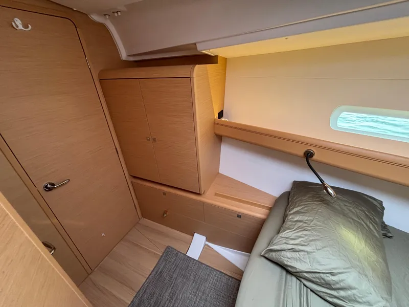 Slide: The Image of Cozy cabin interior of 2019 Jeanneau Sun Odyssey 419 sailboat with wooden furnishings. - 11
