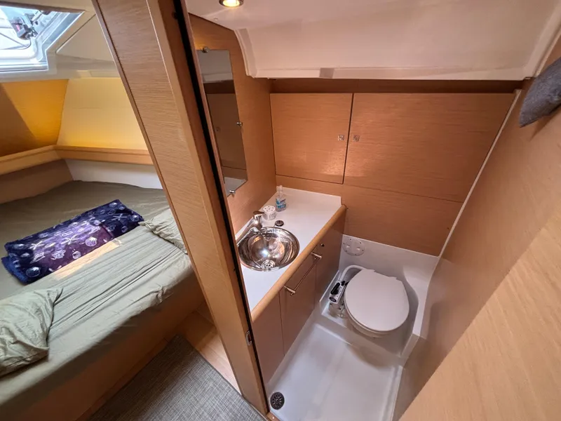 Slide: The Image of 2019 Jeanneau Sun Odyssey 419 interior with cozy cabin and compact bathroom. - 12