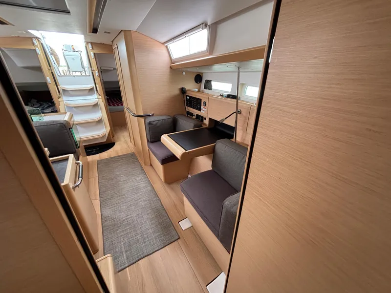 Slide: The Image of 2019 Jeanneau Sun Odyssey 419 interior with modern wood finish and seating area. - 13