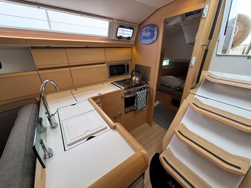 Slide: The Image of 2019 Jeanneau Sun Odyssey 419 interior with modern kitchen and cozy cabin. - 15